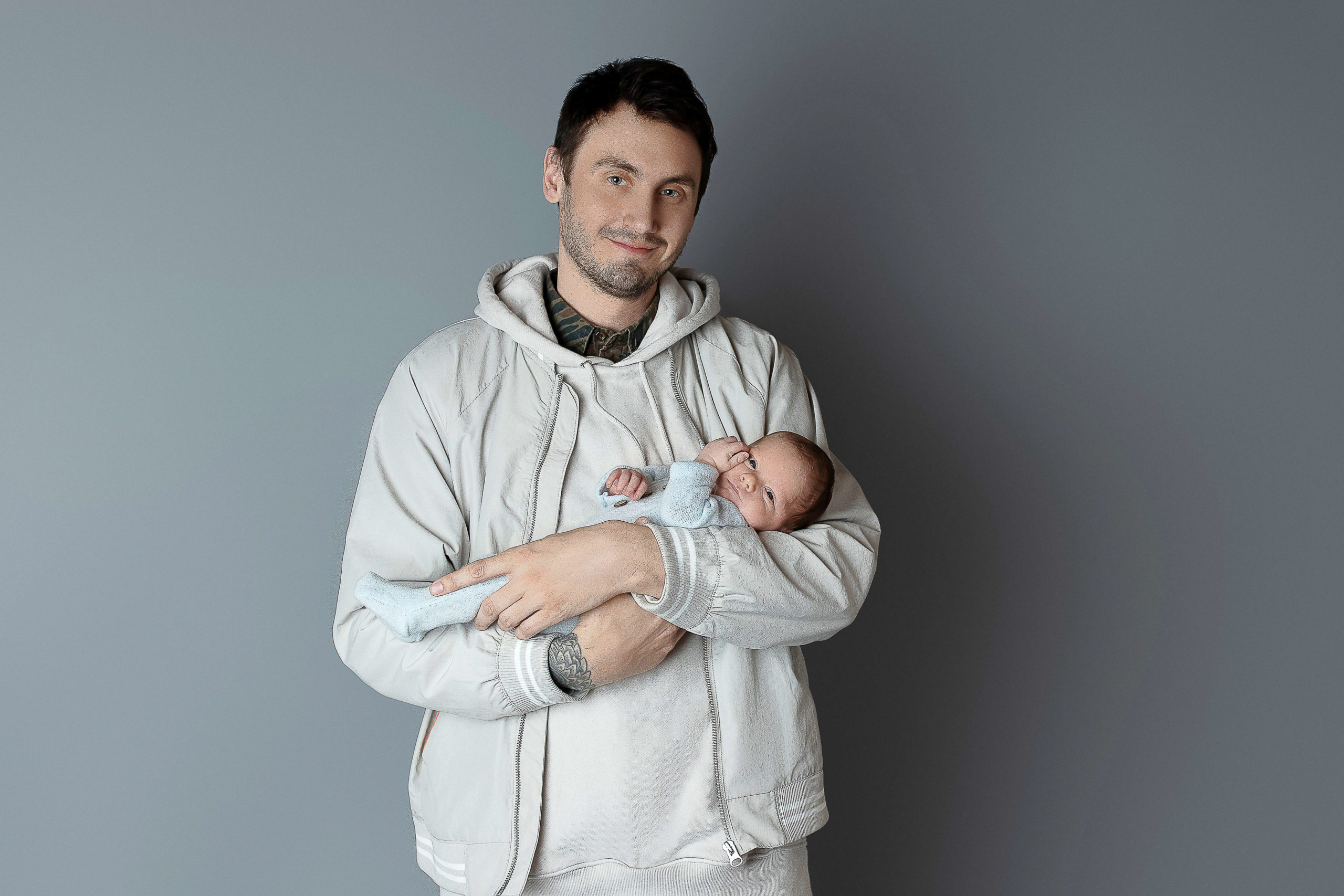 Dad holding his newborn baby in his arms