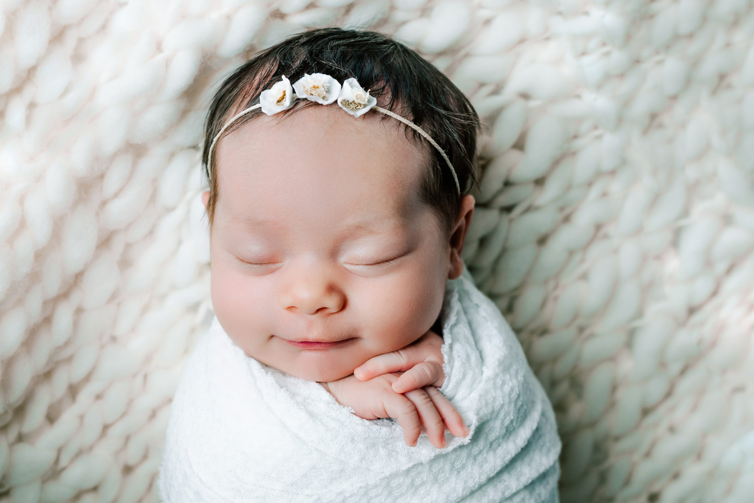 lifestyle newborn photography picture of baby in a cream wrap