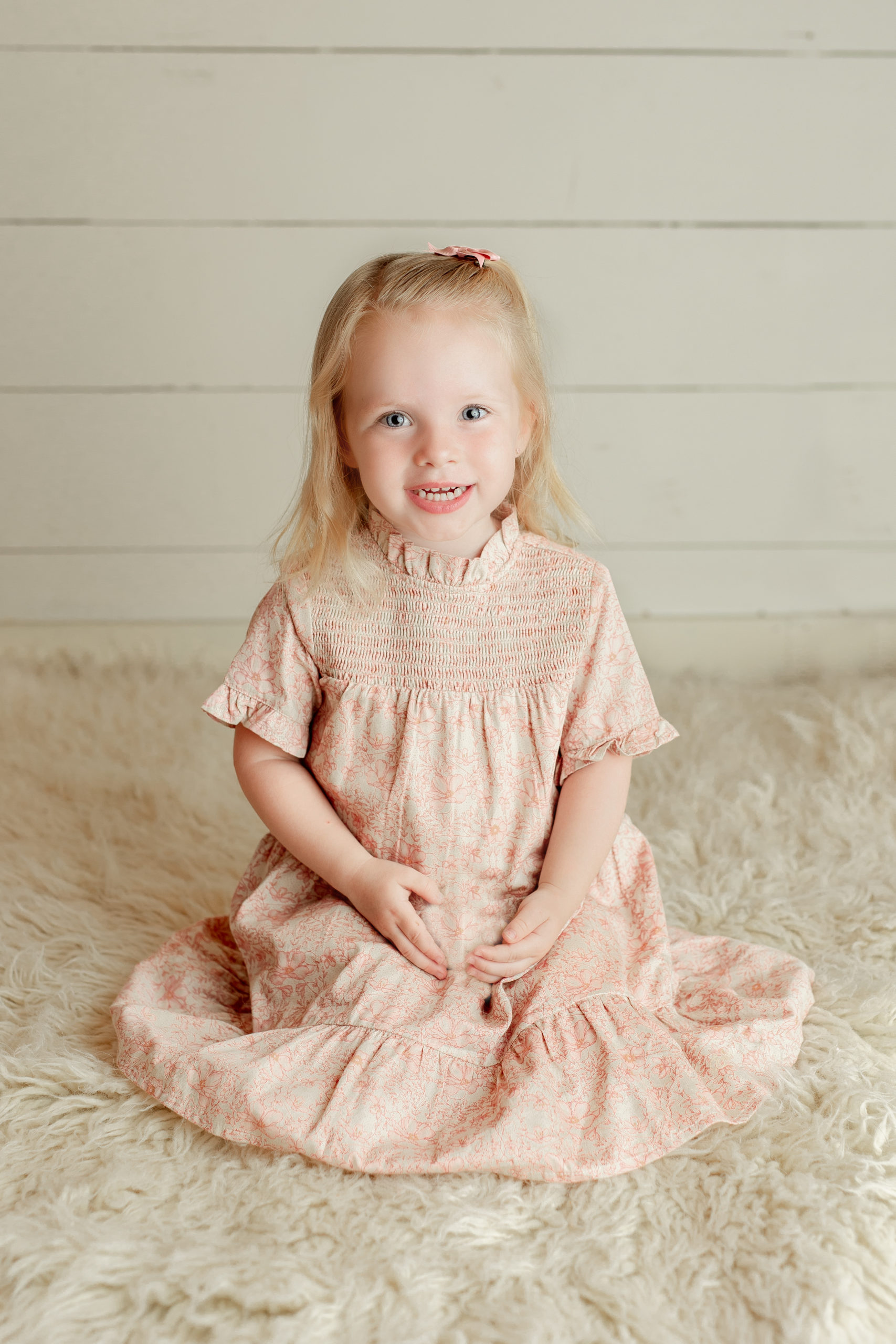 Milwaukee Family Photography studio with a picture of a girl for her third birthday wearing a pale cream floral dress