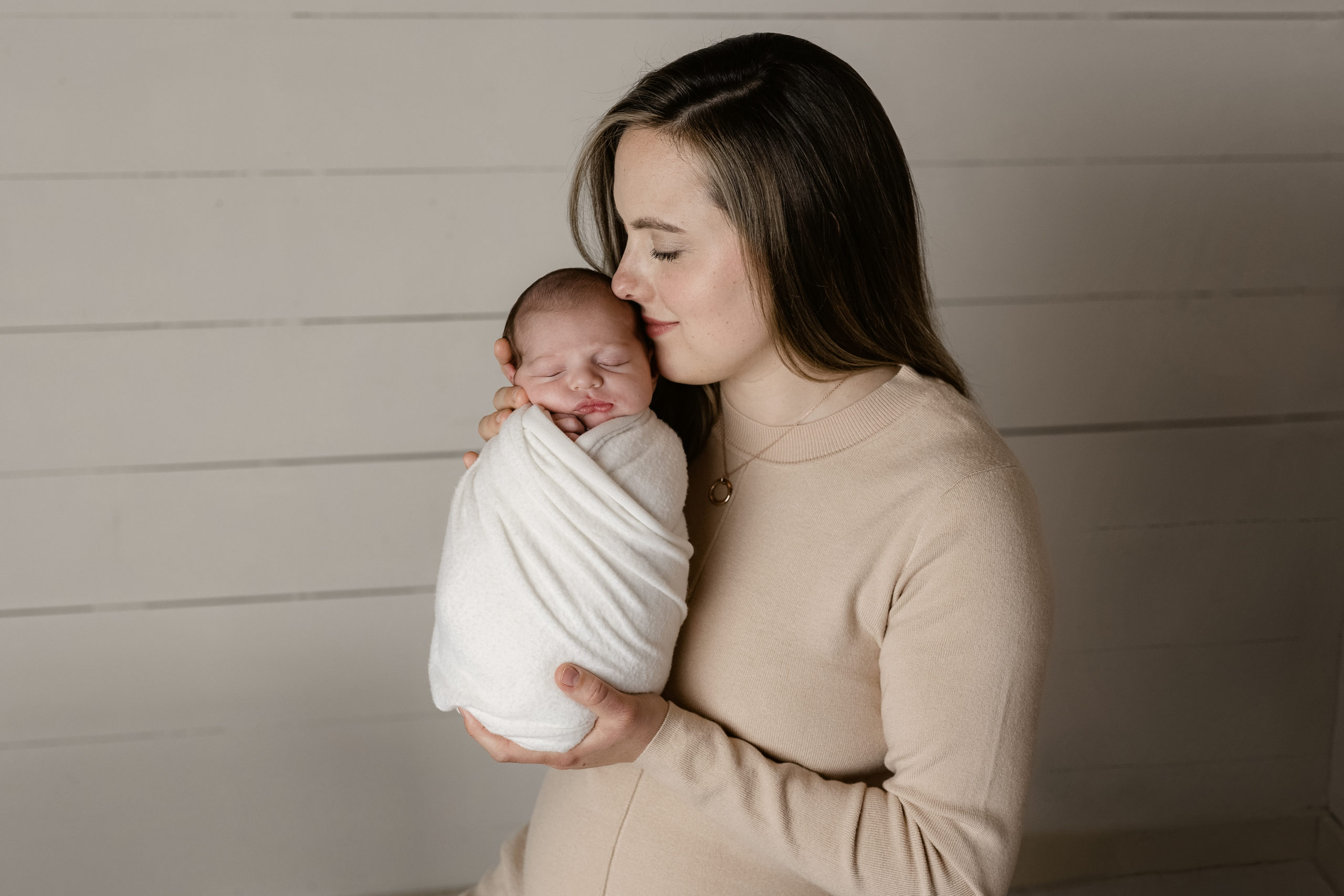 A new mom adoring her baby boy for newborn pictures in brookfield