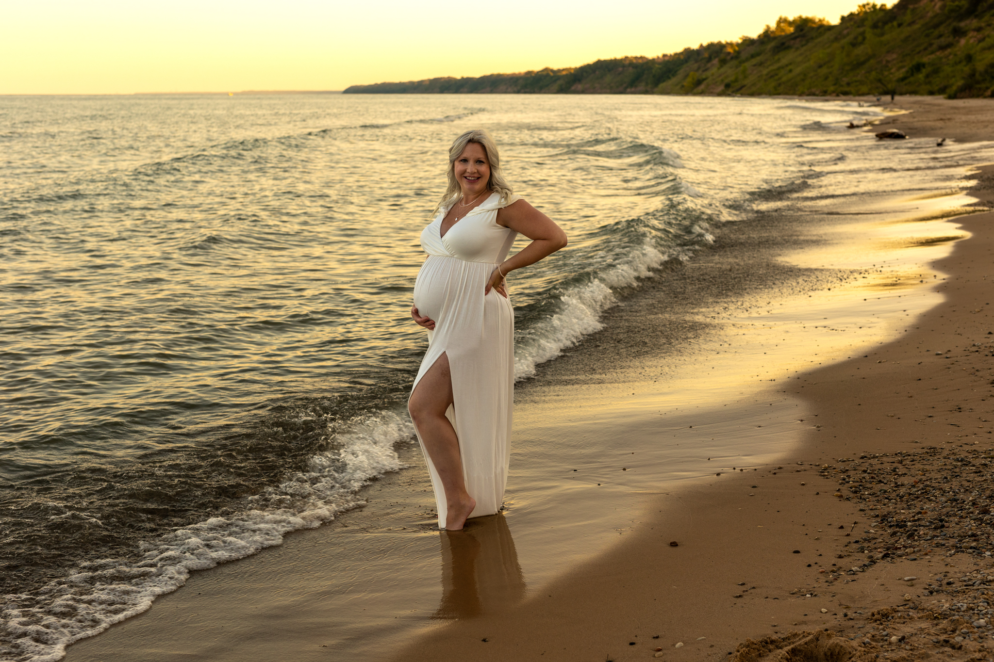pregnant woman in white gown standing near the water Pelvic Floor Therapy Milwaukee
